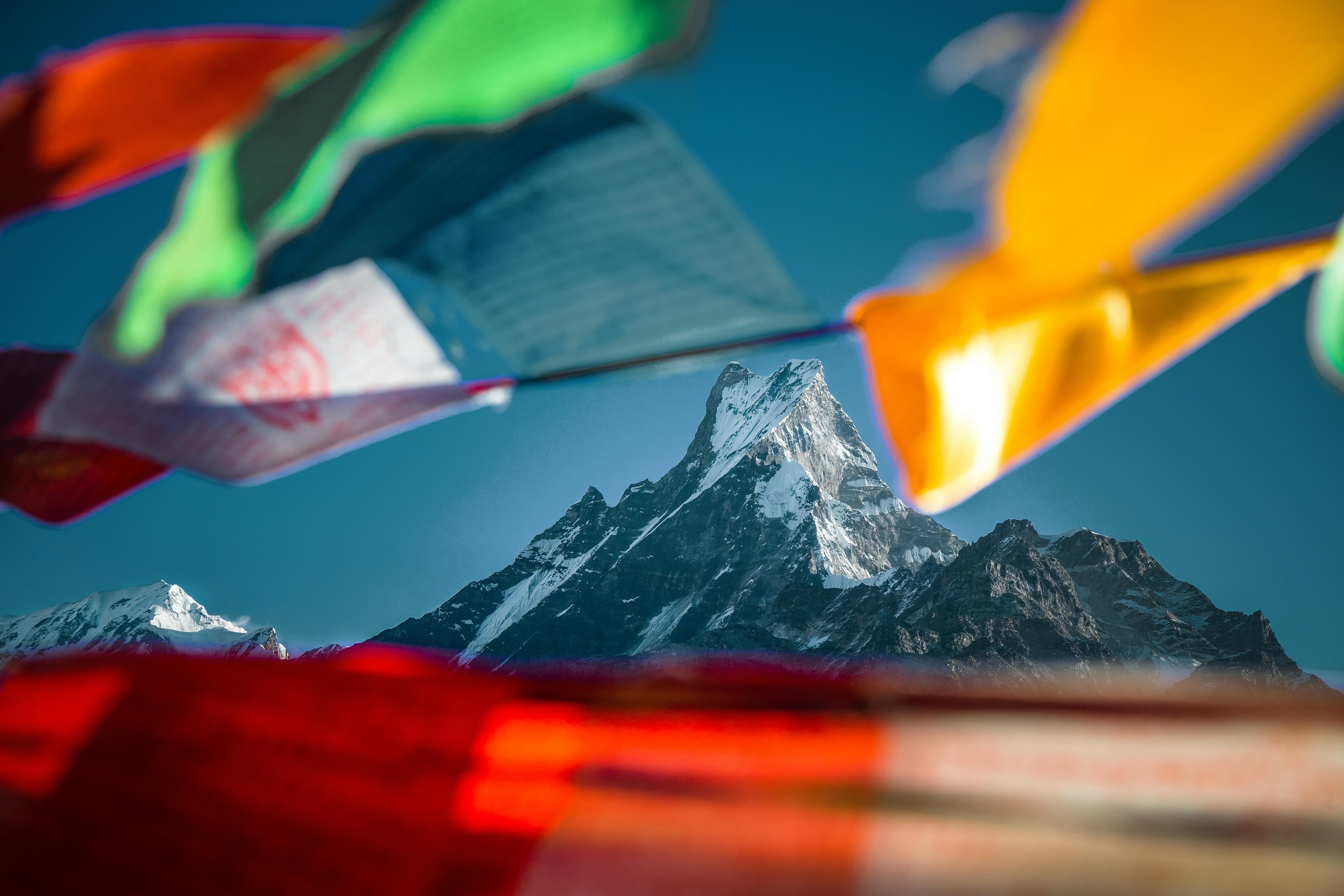 Trekker ascending a snow ridge toward Mount Everest at sunrise